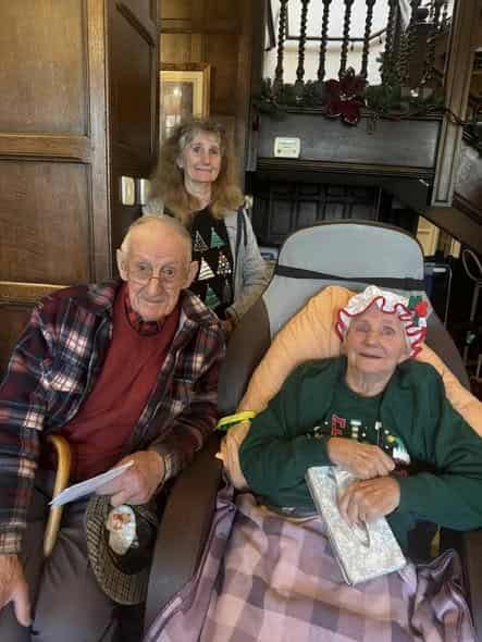 Residents and care staff sharing Christmas cheer in the oak hall