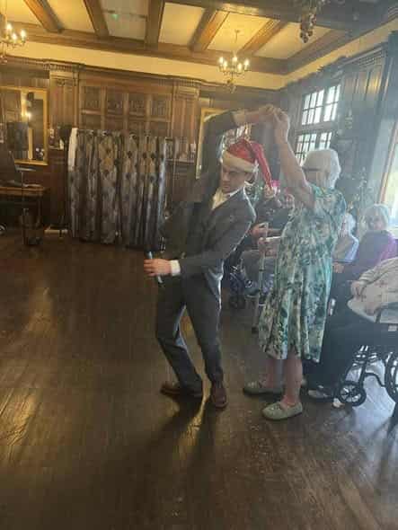 Visiting live ballroom singer and resident dancing in the hall