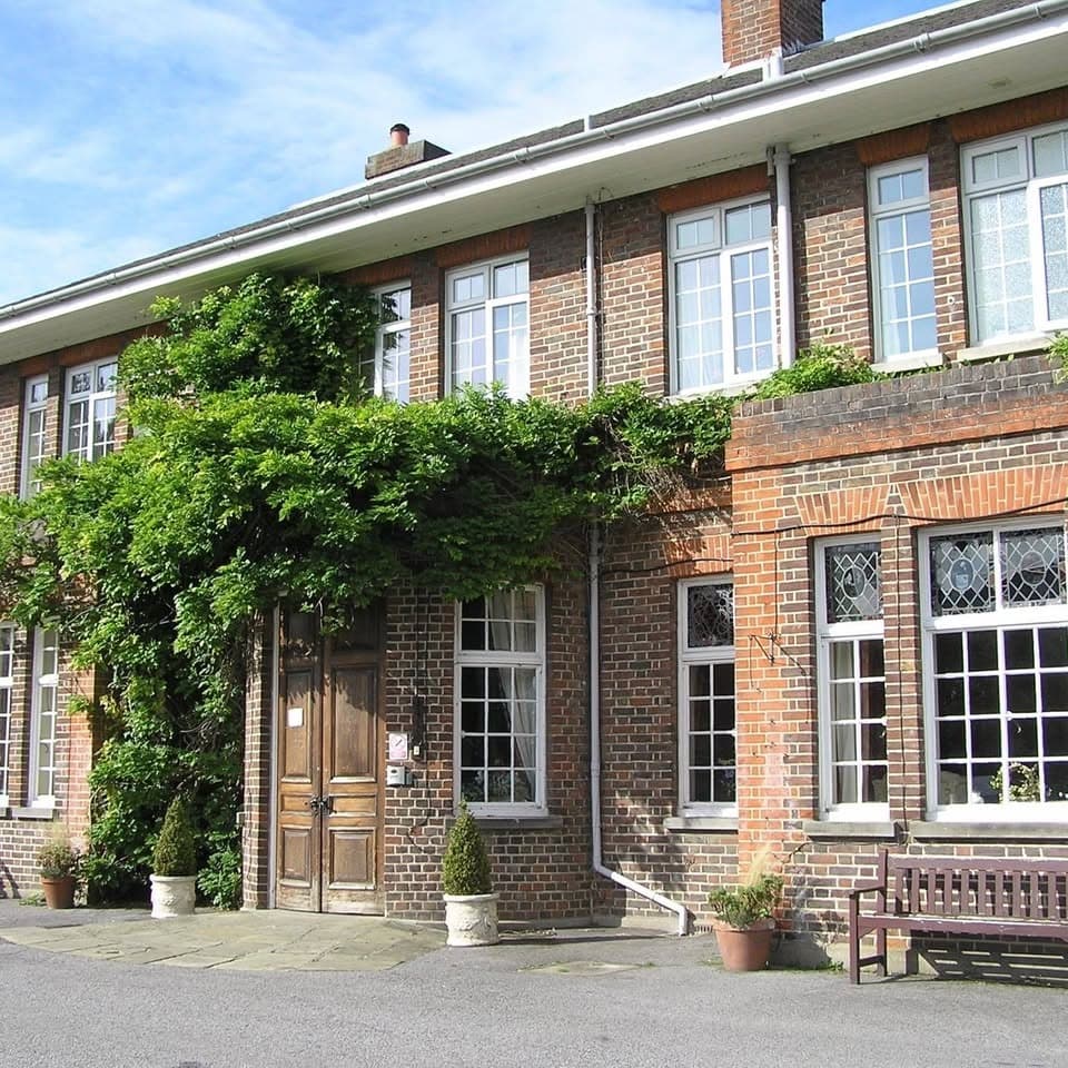 Exterior brick facade and wisteria entrance of Stewton House Nursing Home